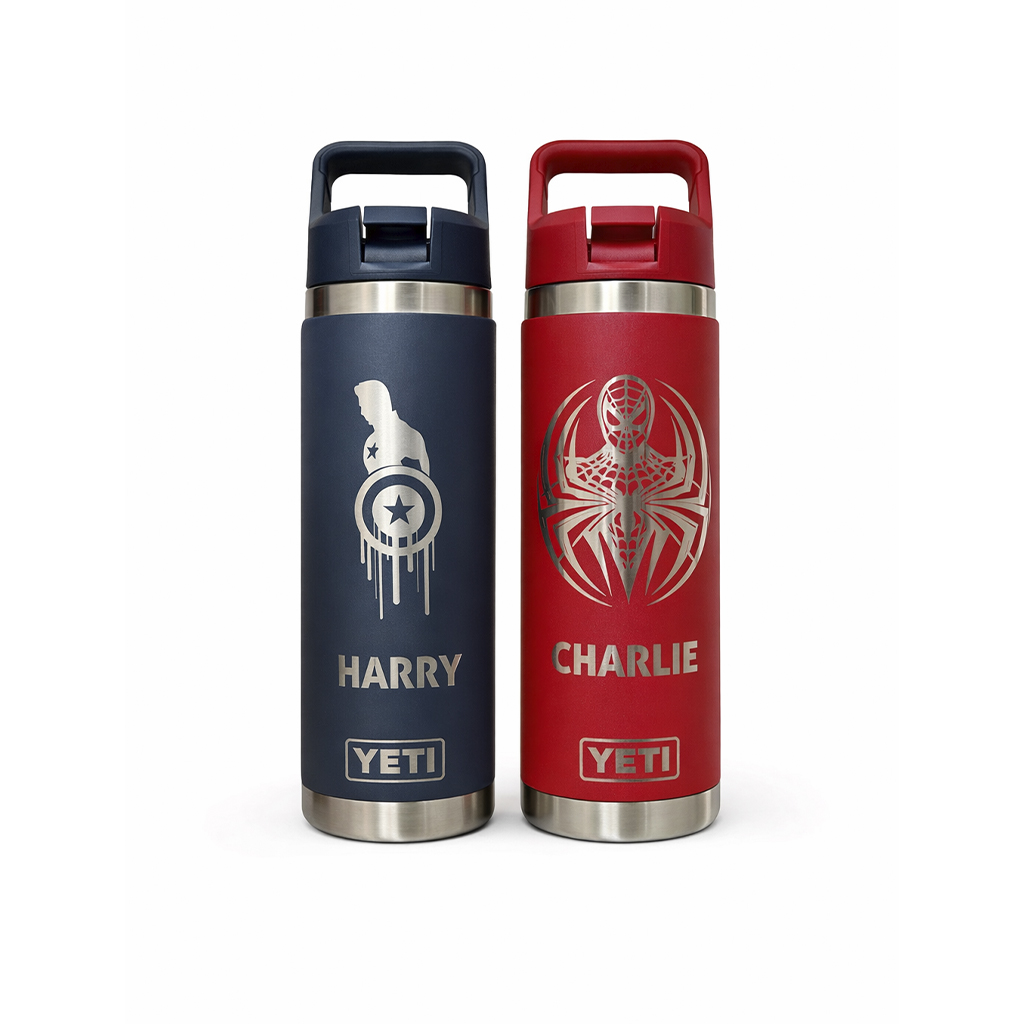Two YETI stainless steel bottles stand side by side: navy blue with Captain America shield and the name Harry, and red with Spider-Man emblem and the name Charlie.